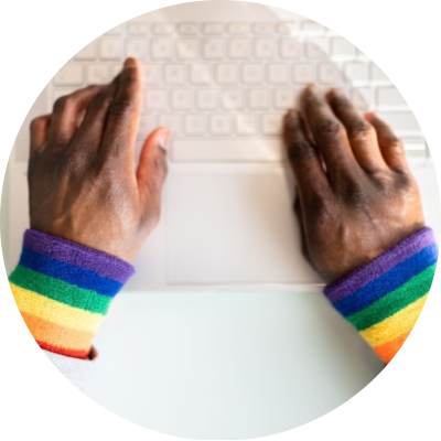 Two hands and arms with rainbow sweatpants on wrist